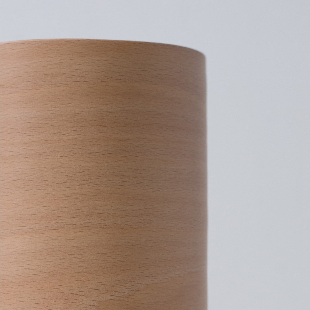 Close-up of Japanese living room lamp showing fine wood grain and curved BUNACO beech shade.
