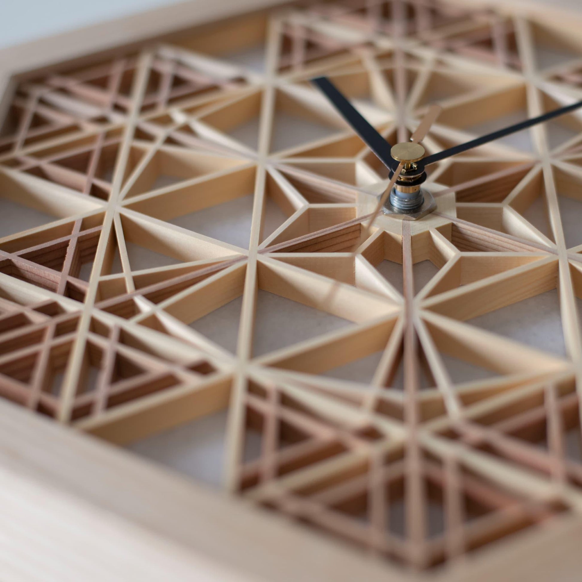 Detailed view of a Japanese kumiko clock, showcasing the intricate patterns created by joining small wooden pieces.