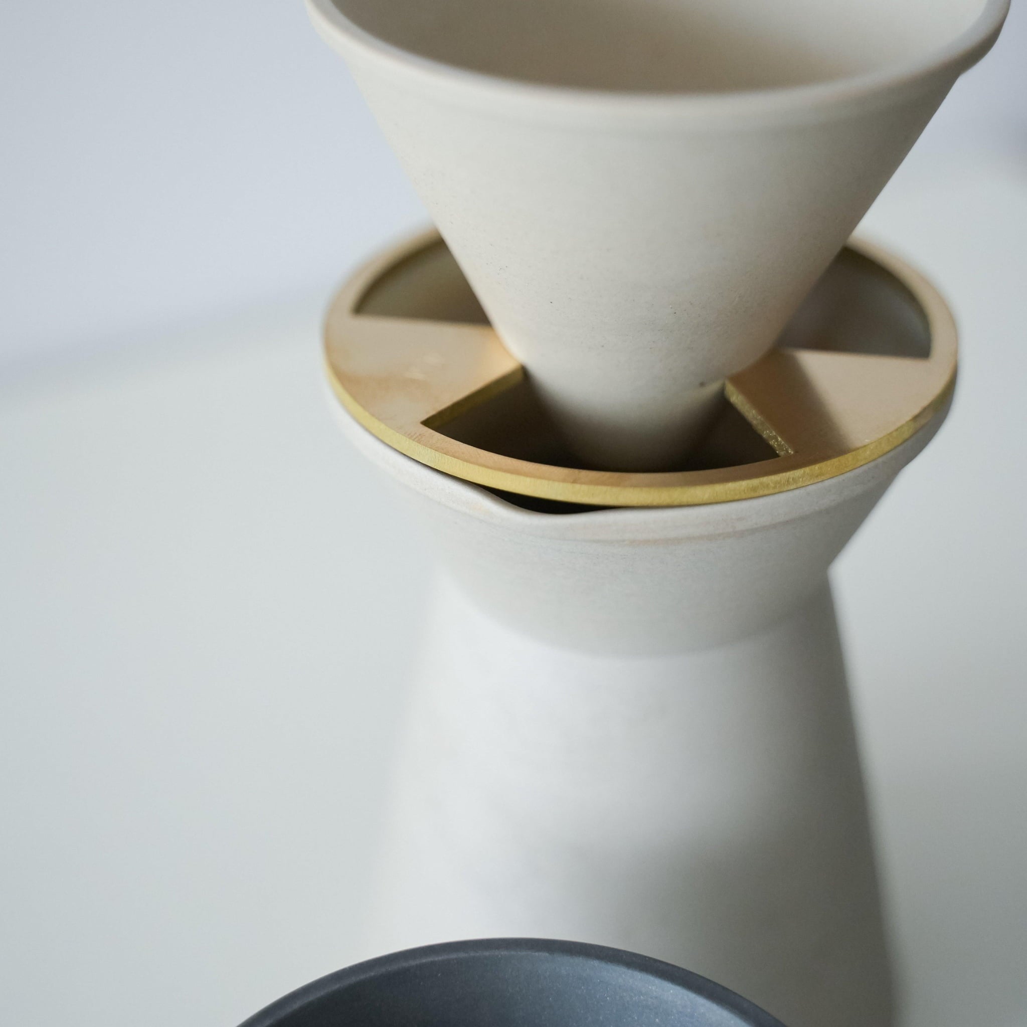 A minimalist white coffee server crafted with traditional Japanese Banko-yaki ceramic, featuring a smooth curve and matte finish.
