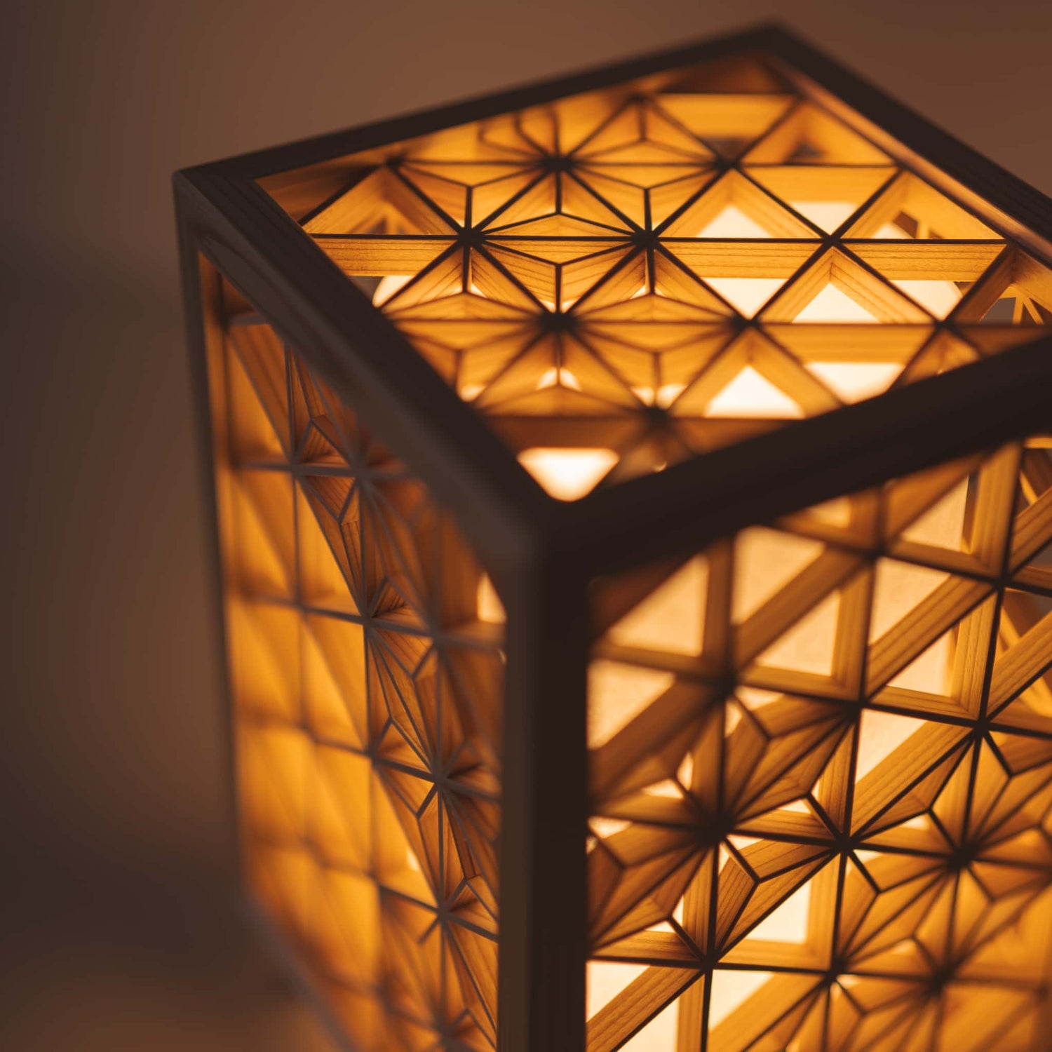 Kumiko lantern with traditional Japanese patterns emits a warm light