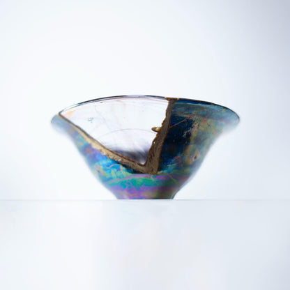 A magnified view of a Kintsugi bowl, highlighting the intricate details of the repair and the beautiful color combination of cherry blossom and sky blue.