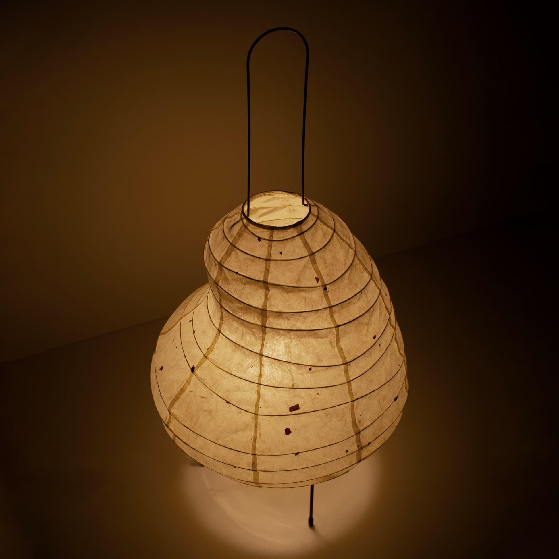 Close-up of a unique bean-shaped paper floor lamp made with Gifu lantern techniques and Mino washi paper.