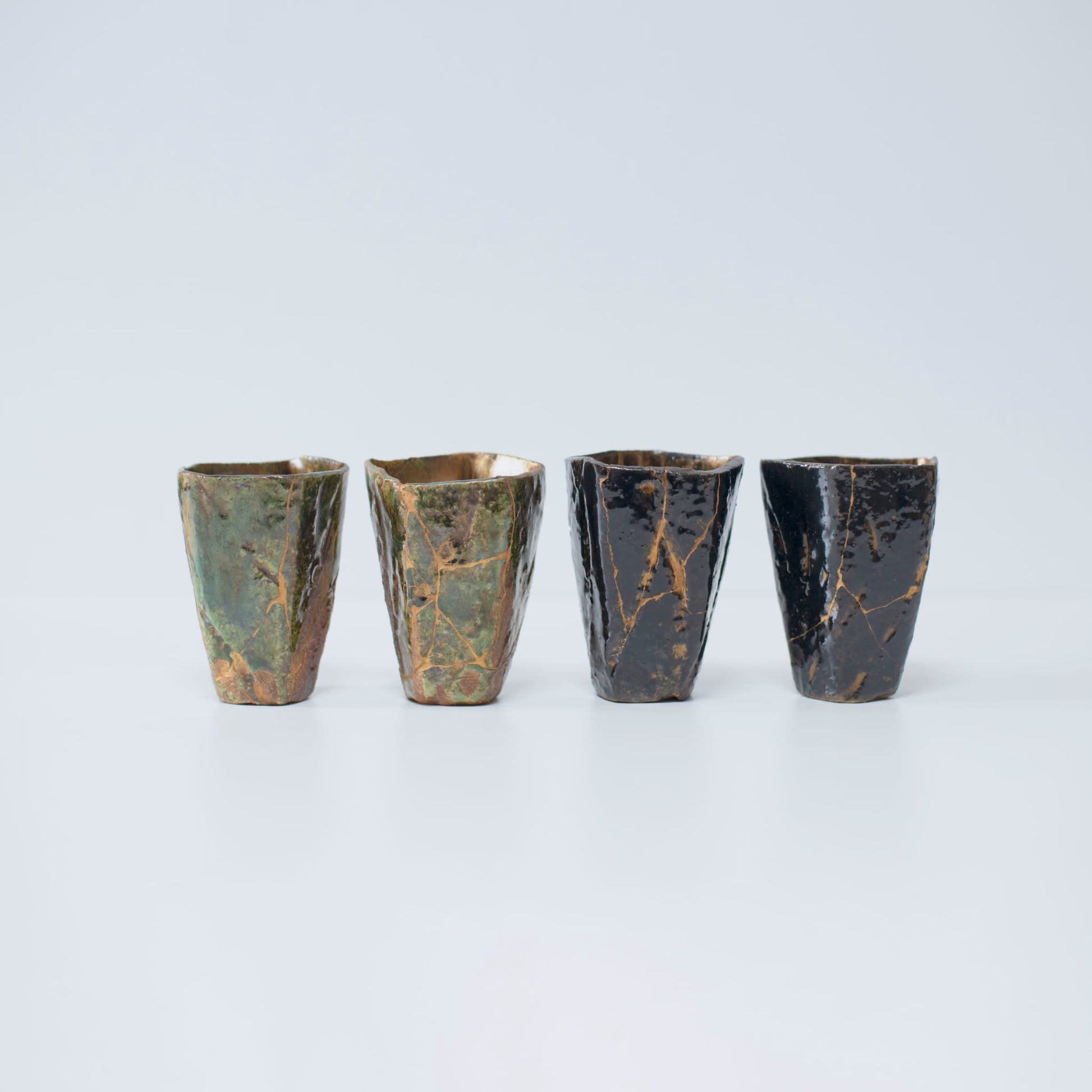 Four Pentagon Kintsugi Cups: Two "Oribe" Deep Green and two "Tenmoku" Black