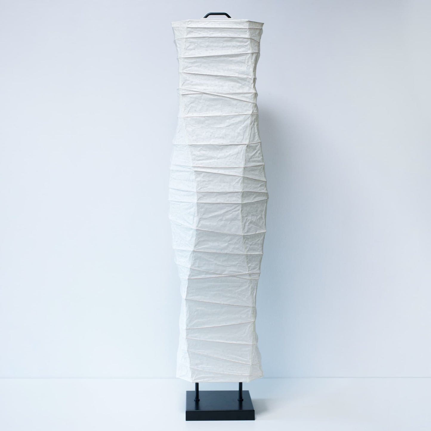 A full front view of a Japanese washi paper lamp with elegant curves, photographed on a clean white background