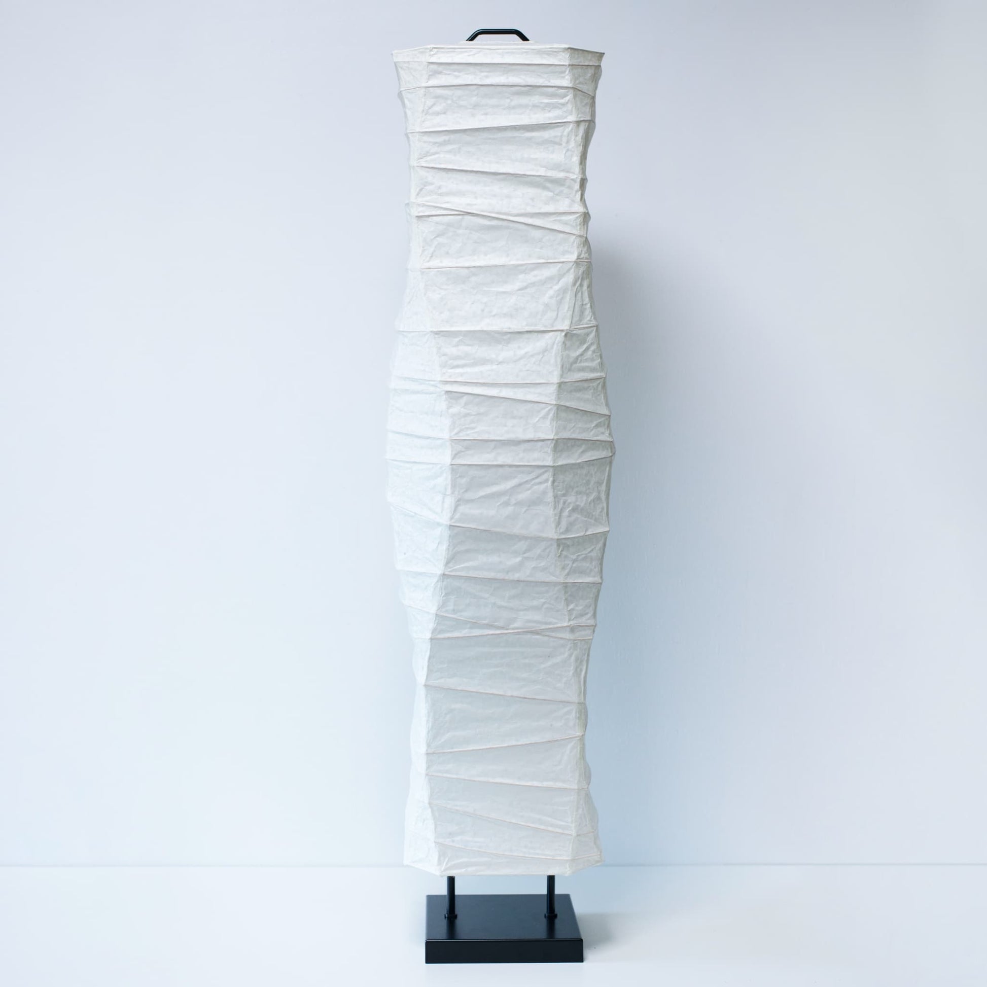 A full front view of a Japanese washi paper lamp with elegant curves, photographed on a clean white background