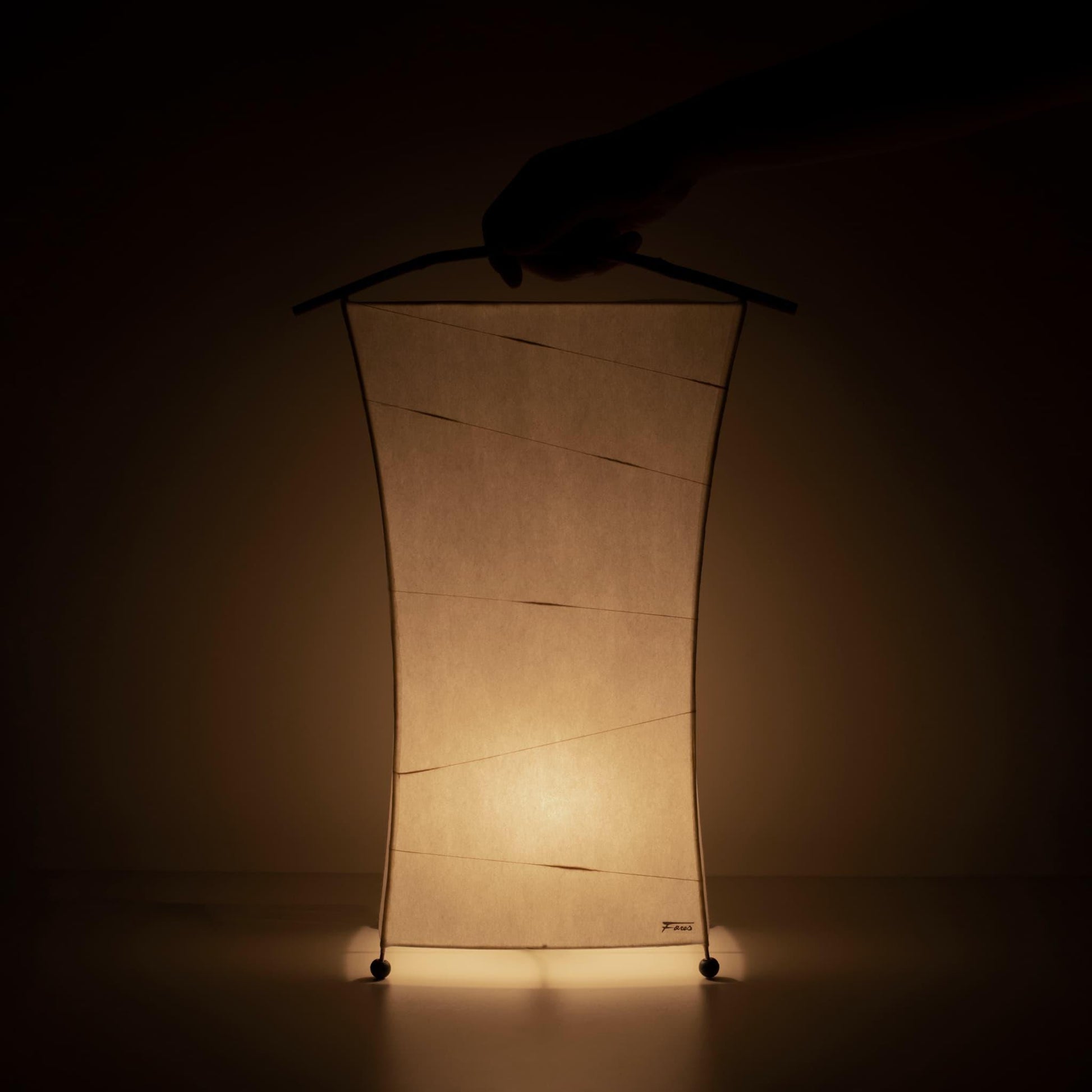 Hand holding a unique paper floor lamp crafted with Gifu lantern techniques and 1300-year-old Mino washi paper.