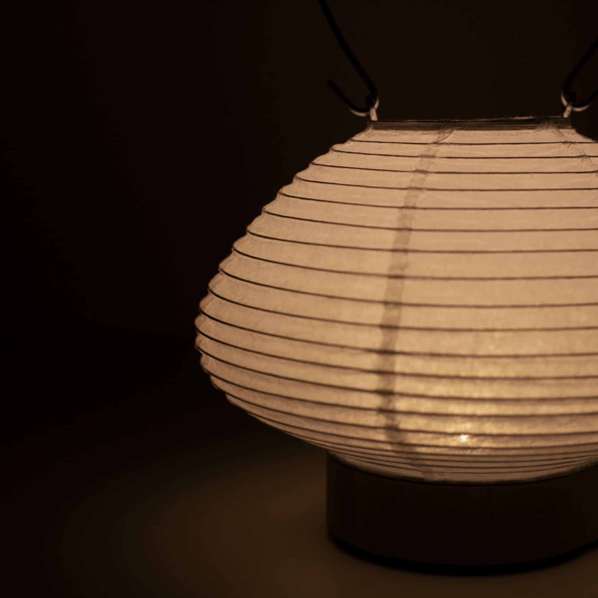 Portable table lamp resembling a traditional Japanese lantern, crafted with Gifu lantern techniques and Mino washi paper.