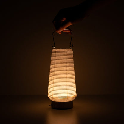 Hand holding slim Japanese paper table lamp RIN 04, portable vertical Japanese paper lamp
