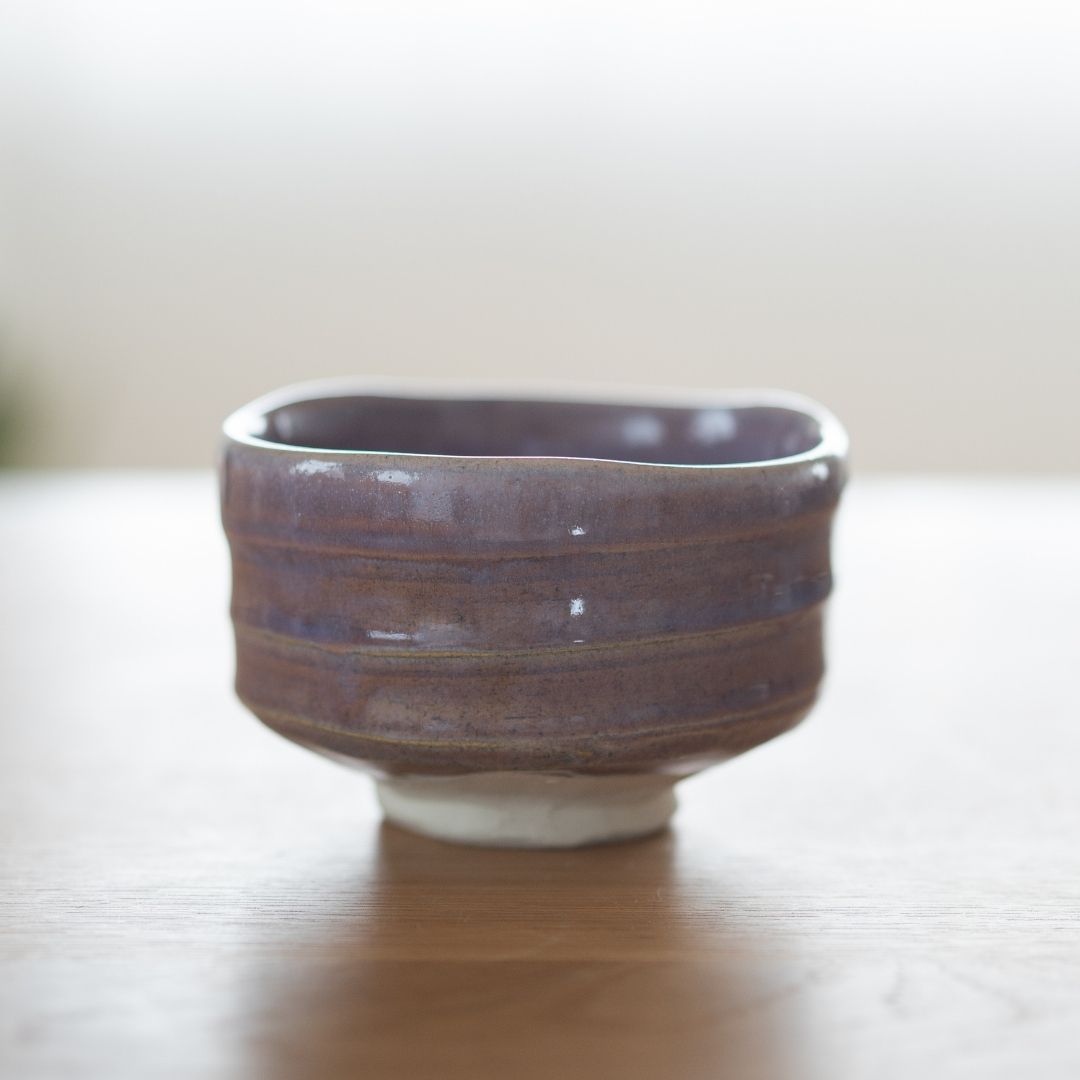 Full view of a handcrafted Pale Violet matcha chawan bowl with modern Japanese aesthetics, featuring hand-carved ridges and a white porcelain base, embodying serene elegance.