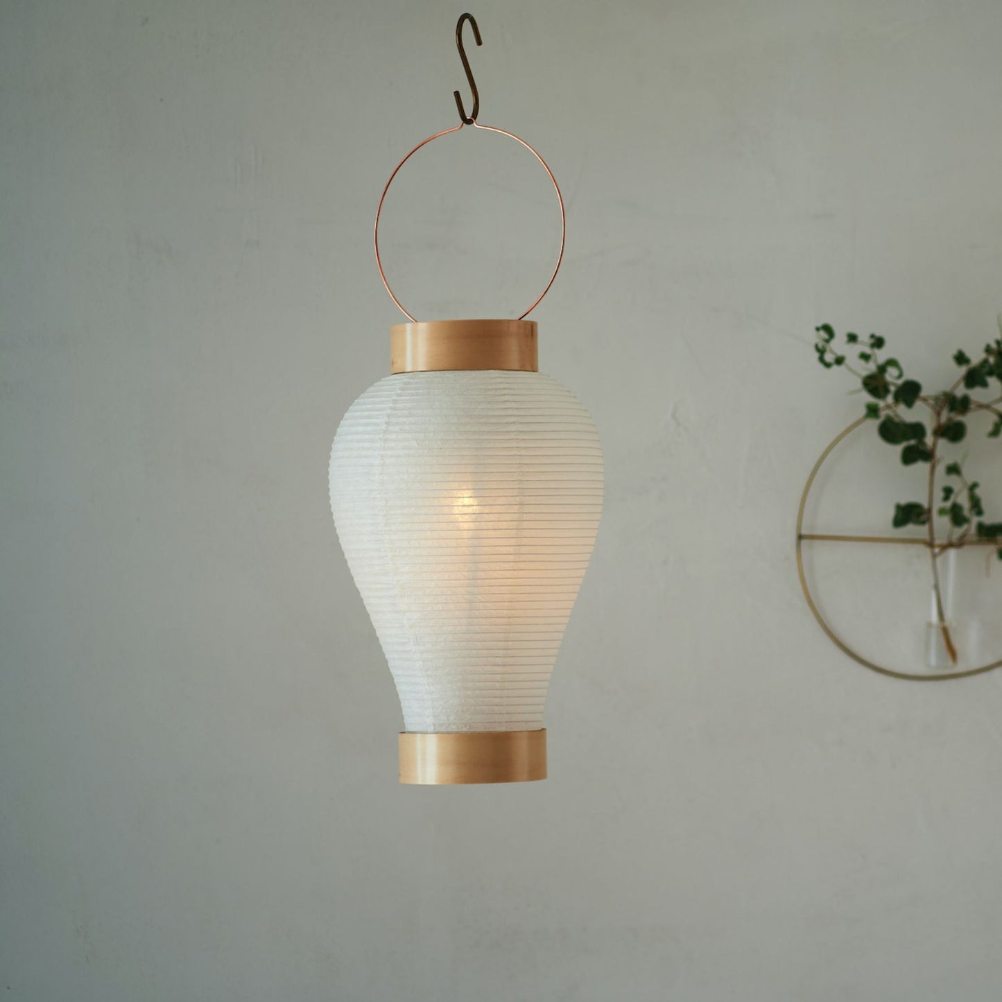 A traditional Japanese paper lantern hanging from above, softly glowing