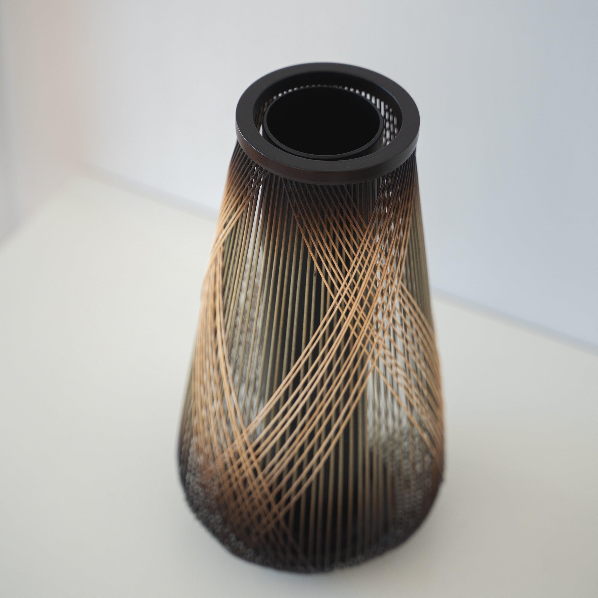 Handcrafted Japanese bamboo vase, meticulously crafted by skilled artisans using traditional bamboo weaving techniques, showcasing the natural beauty and elegance of bamboo.