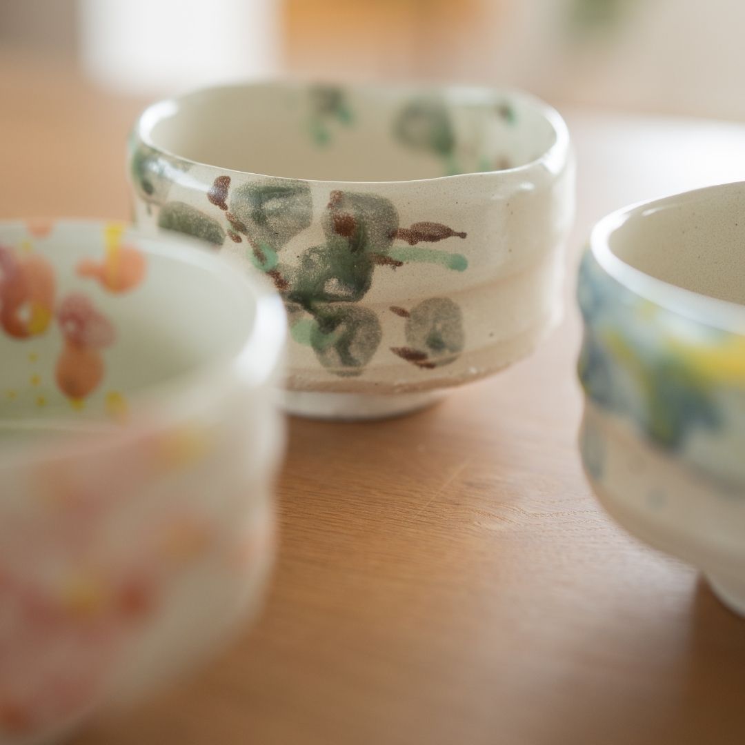 The "Forest" matcha bowl displayed in a setting that highlights its organic form and Wabi Sabi aesthetic, handcrafted by Shinzan Kiln artisans in Gifu.