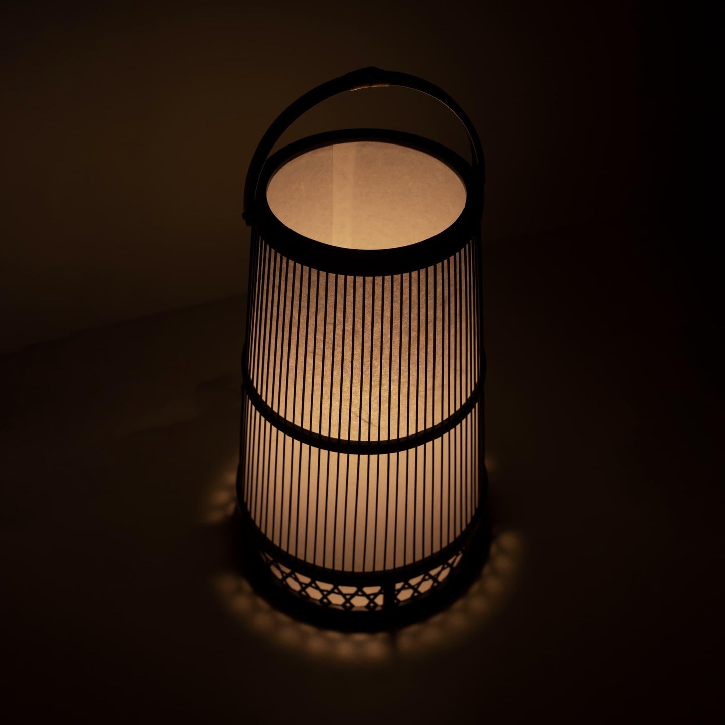 Japanese lamp crafted with 800-year-old Shizuoka bamboo artistry. Delicate bamboo strips create intricate patterns, casting a warm glow through Japanese paper.