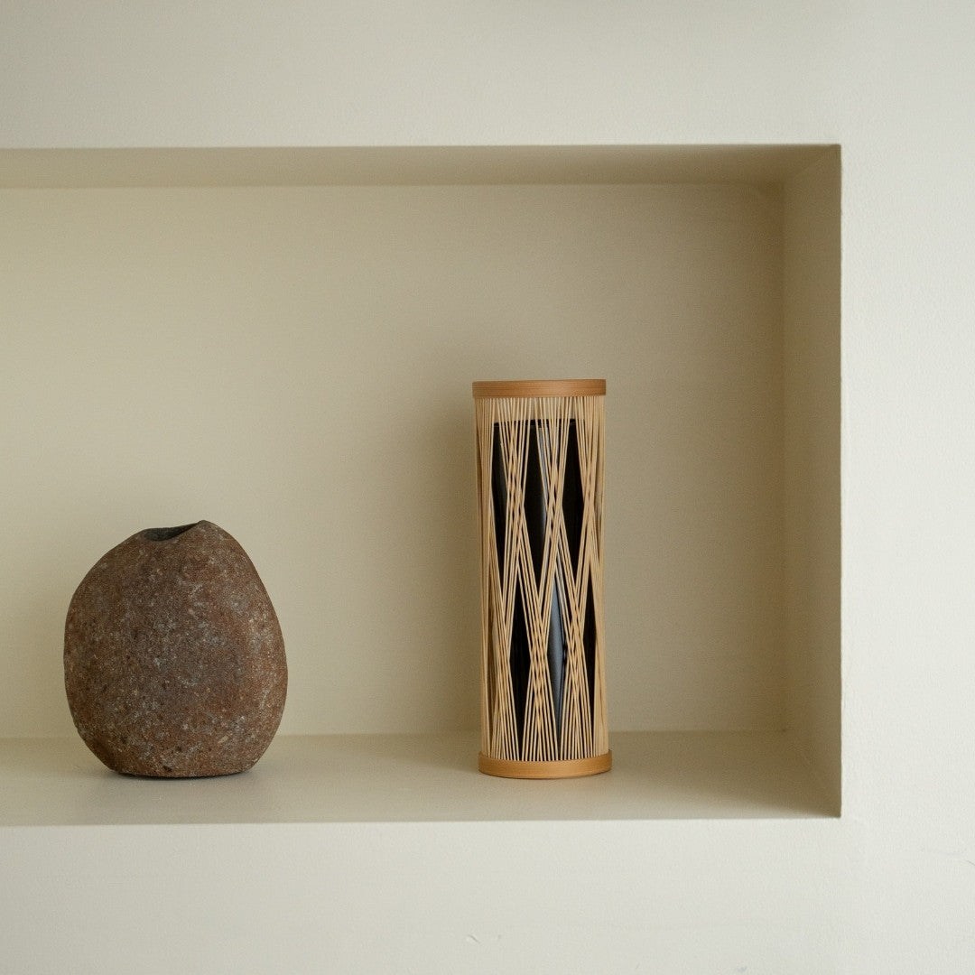 Japanese Bamboo Flower Vase “Entwined Branch” on a white shelf - Stylish ikebana flower vase for Japandi style room