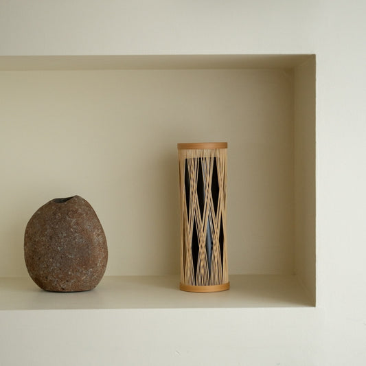 Japanese Bamboo Flower Vase “Entwined Branch” on a white shelf - Stylish ikebana flower vase for Japandi style room