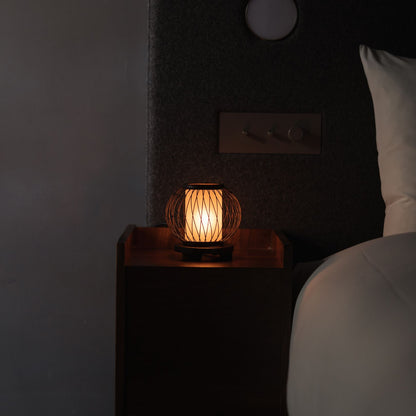 A bamboo table lamp "Moon Rabbit" on a bedside table. 