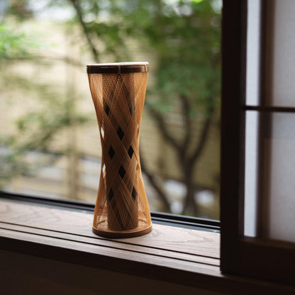 Handcrafted Japanese bamboo vase, meticulously crafted by skilled artisans using traditional bamboo weaving techniques, showcasing the natural beauty and elegance of bamboo.