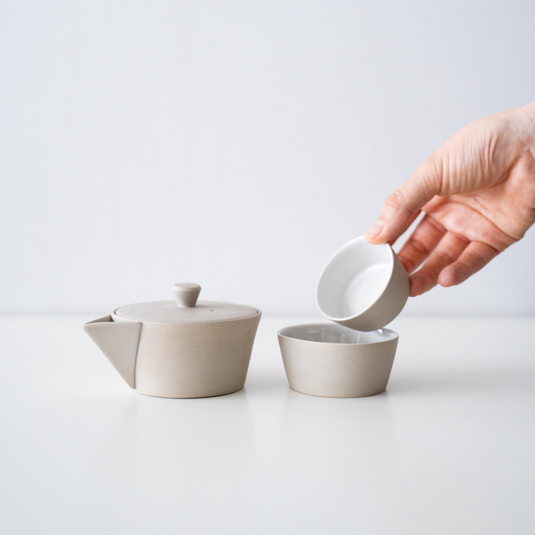 Japanese Banko-yaki nesting tea set with a white teapot and two cups, with a history of several hundred years, presented in a simple paper box.