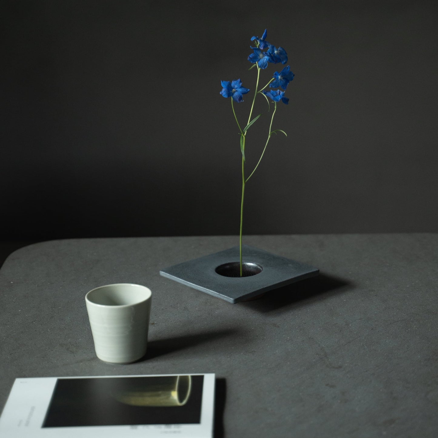 Close-up of a Japanese iron ikebana vase, showcasing the kenzan (flower frog) for arranging flowers.