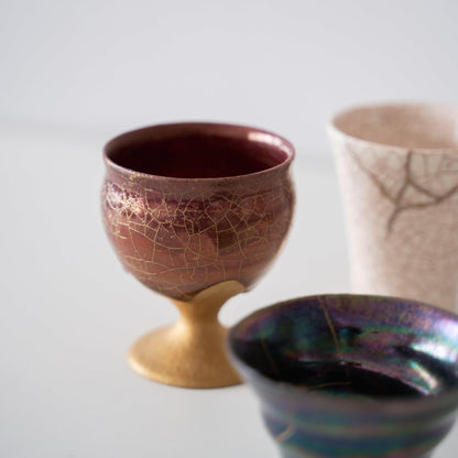 Three Kintsugi Pieces on White Background: Goblet, Cup and Sake Cup