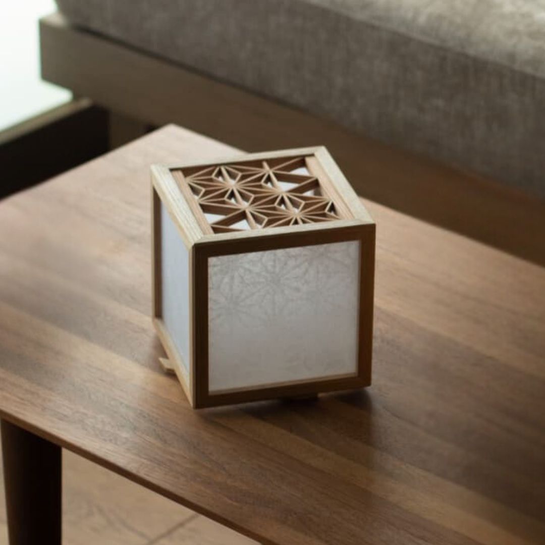 Japanese Kumiko Lantern Cover with intricate woodworking detail on a wooden table