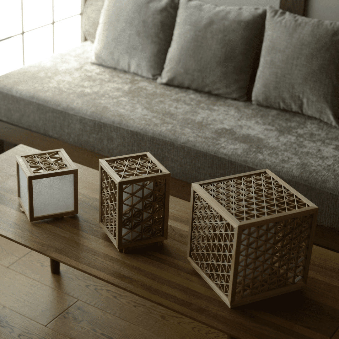 Three Japanese kumiko lamps on a wooden table in a Japanese living room. 