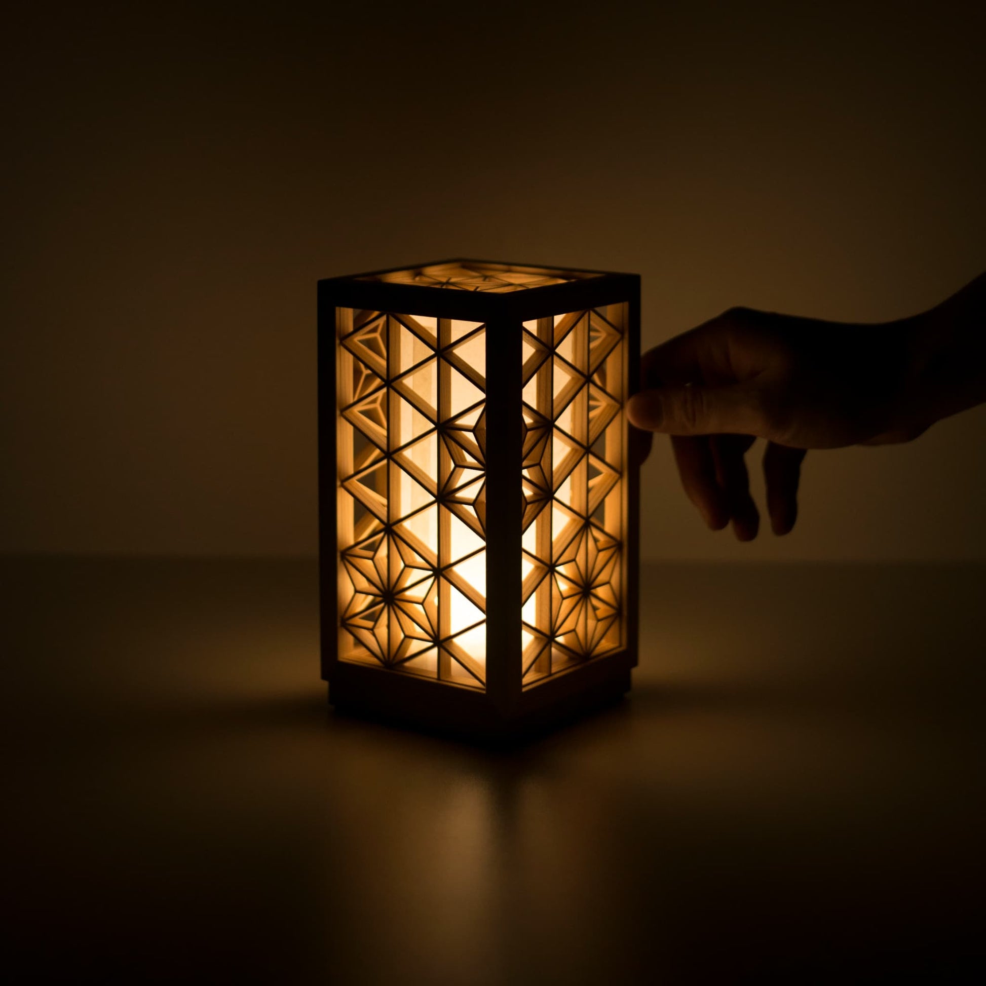 A table lamp using kumiko, a traditional Japanese technique of assembling small wooden pieces to create geometric patterns.