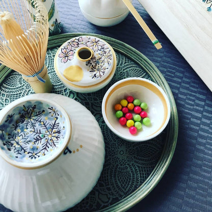 Japanese matcha bowl “Waraku” Snow by Buzan Kiln, featuring a hand-painted snow crystal motif with silver-blue glaze, symbolizing winter tranquility and purity.