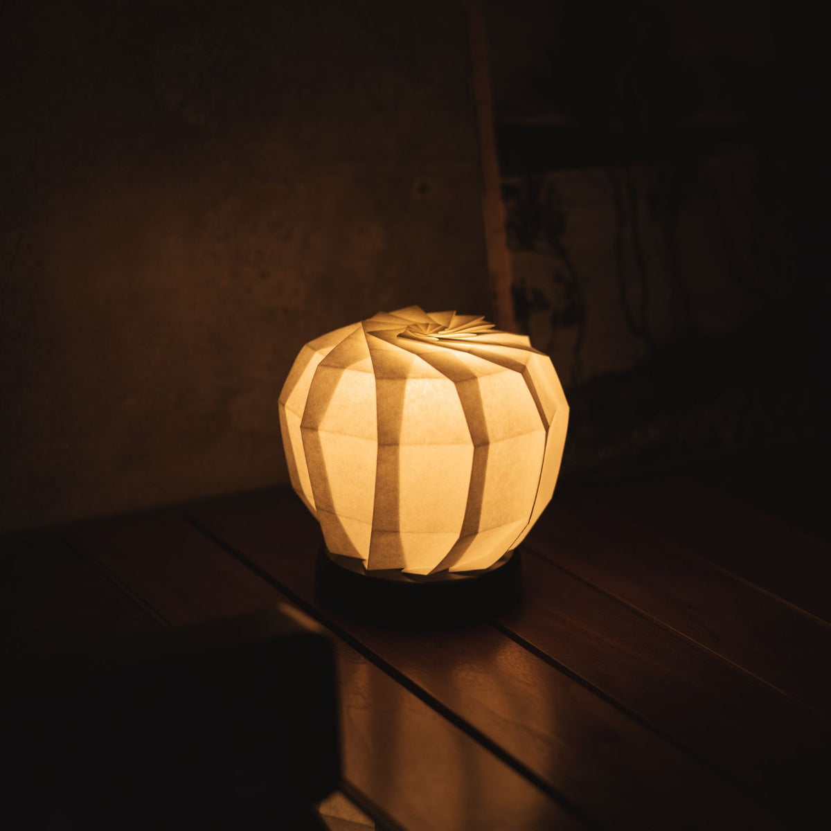 Japanese Paper Origami Table Lamp "Flower of Light maru M" Placed on a Living Room Console Table