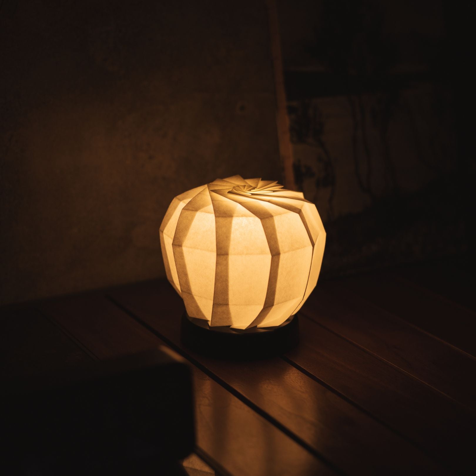 Japanese Paper Origami Table Lamp "Flower of Light maru M" Placed on a Living Room Console Table