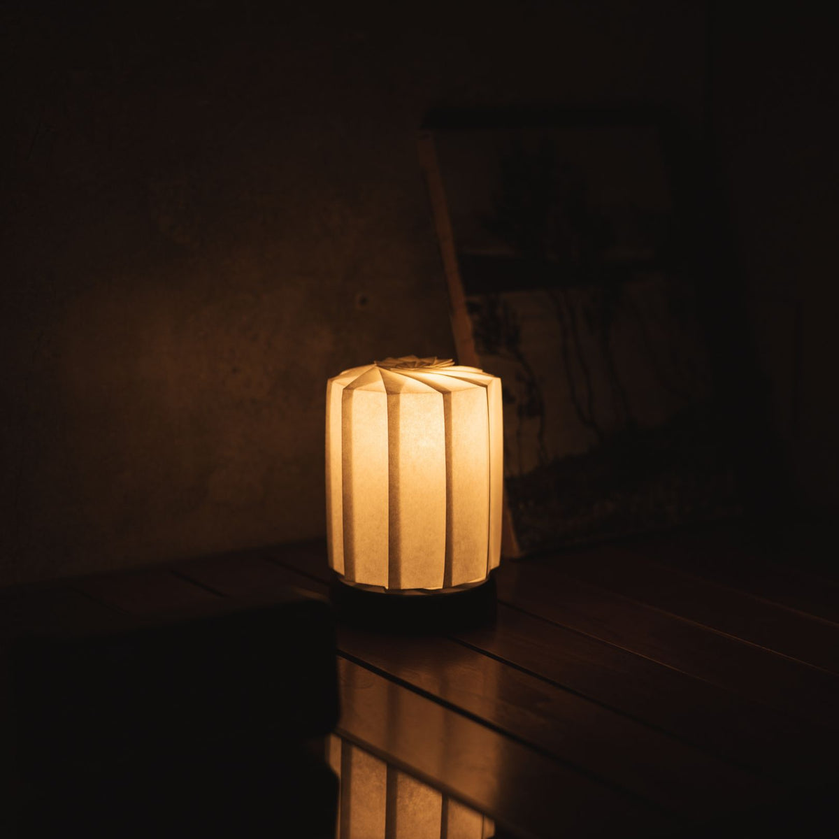 Japanese Paper Origami Table Lamp "Flower of Light tutu M" Placed on a Living Room Console Table