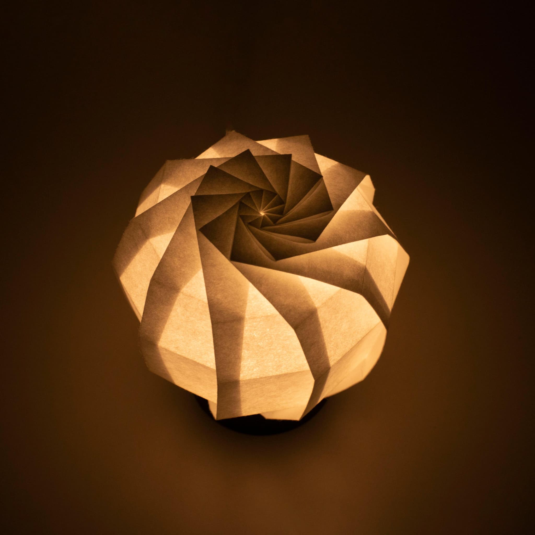 Frameless Japanese table lamp crafted with traditional Kyo-hyogu and origami techniques, featuring a unique illuminated origami pattern.