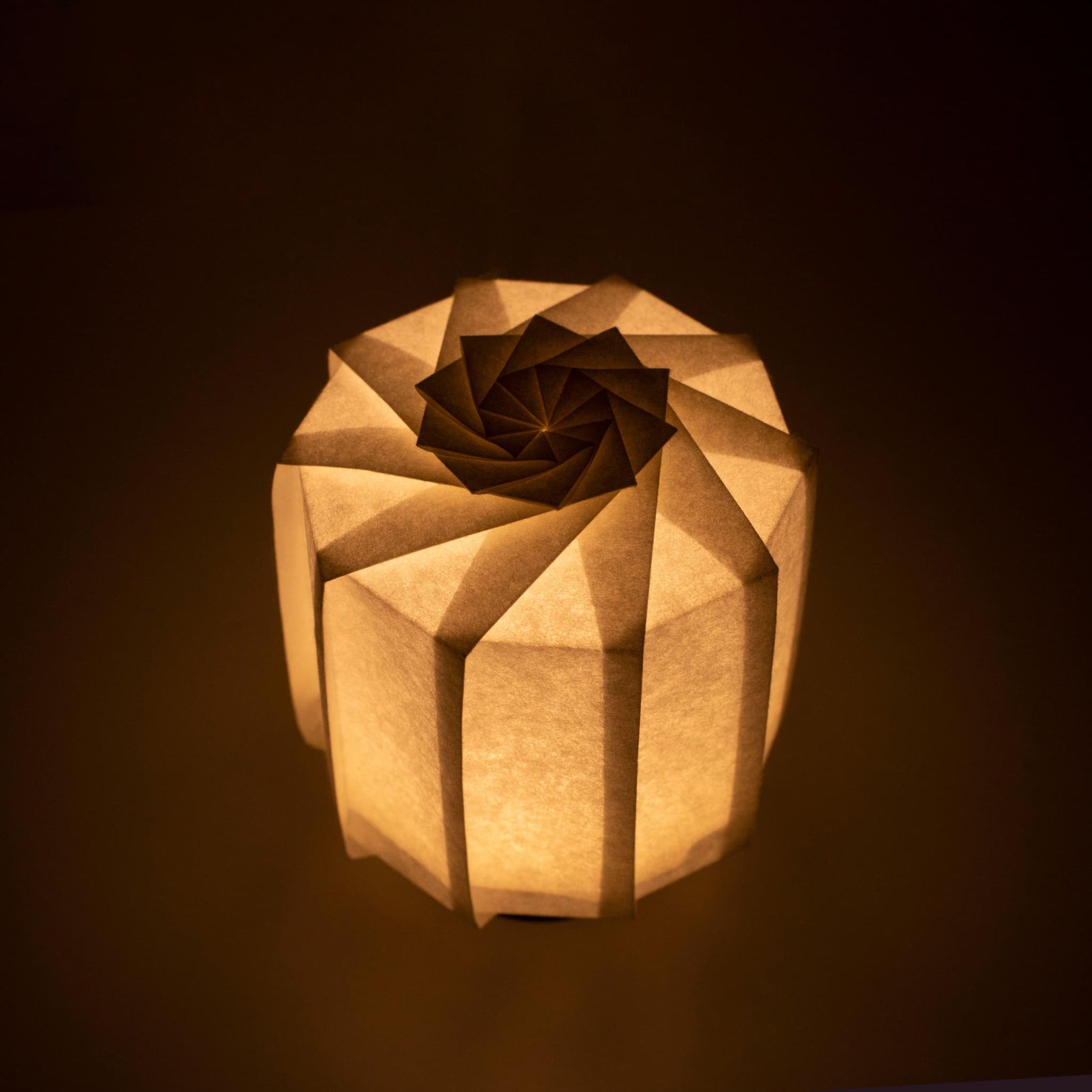 Frameless Japanese table lamp crafted with traditional Kyo-hyogu and origami techniques, featuring a unique illuminated origami pattern.