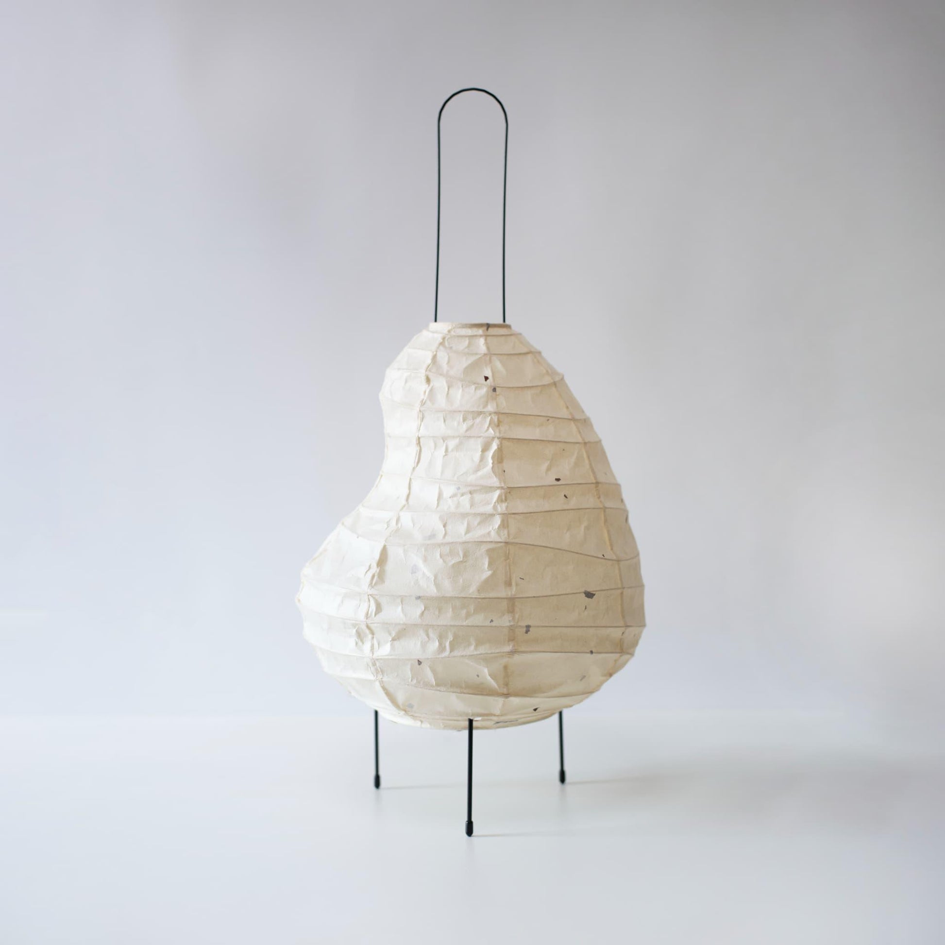 Unique bean-shaped  paper floor lamp blending Gifu lantern techniques and 1300-year-old Mino washi paper.