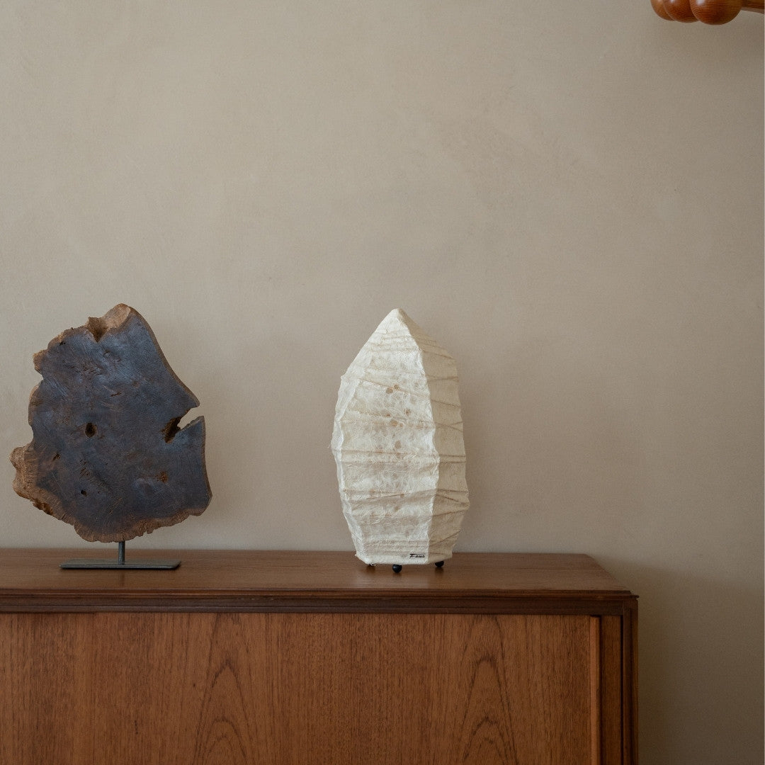 Japanese Paper Floor Lamp “Paper Stone” Small on a wood table in Japandi living room - Japandi nightstand lamp for bedroom