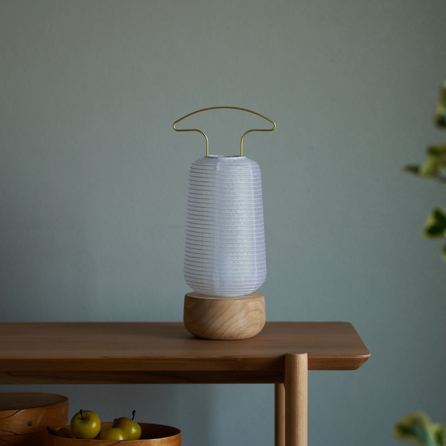 A traditional Japanese paper lantern on a wooden desk