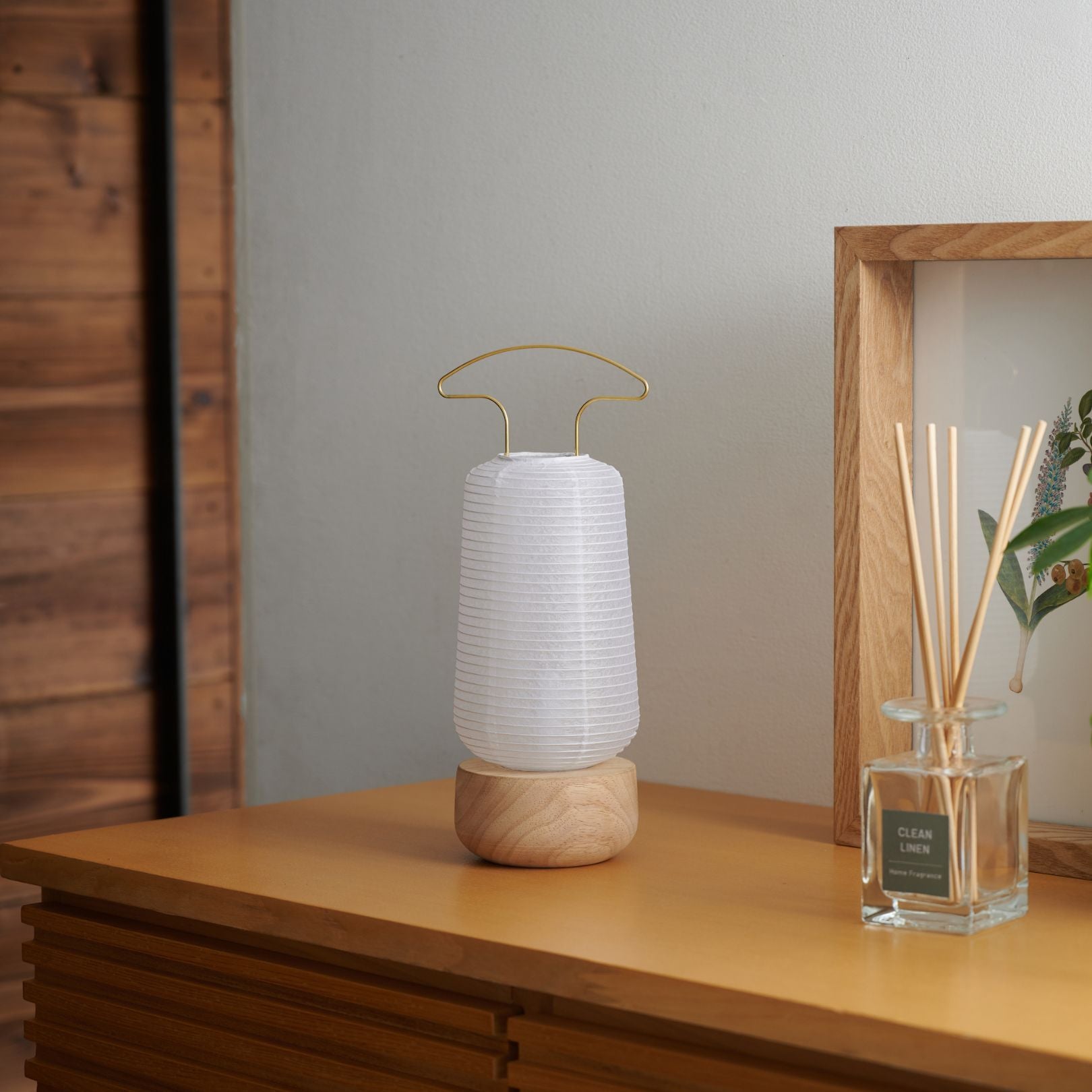 A traditional Japanese paper lantern placed on a wooden shelf