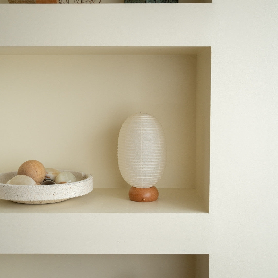 Japanese Paper Table Lamp "Dinosaur" on a white shelf in Japandi style room – Wabi-Sabi Portable night lamp for bedroom