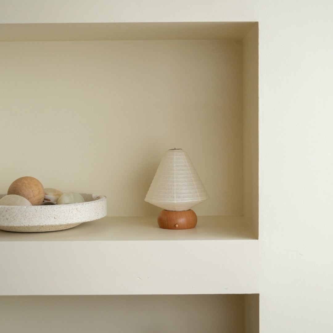 Japanese Paper Table Lamp "Mini Triangle" on a white shelf in Japandi style room – Wabi-Sabi night lamp for bedroom