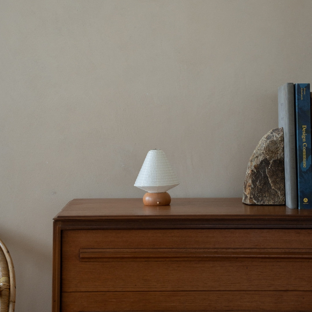 Japanese Paper Table Lamp "Mini Triangle" on wooden shelf in Japandi style room – Unique bedside table lamps