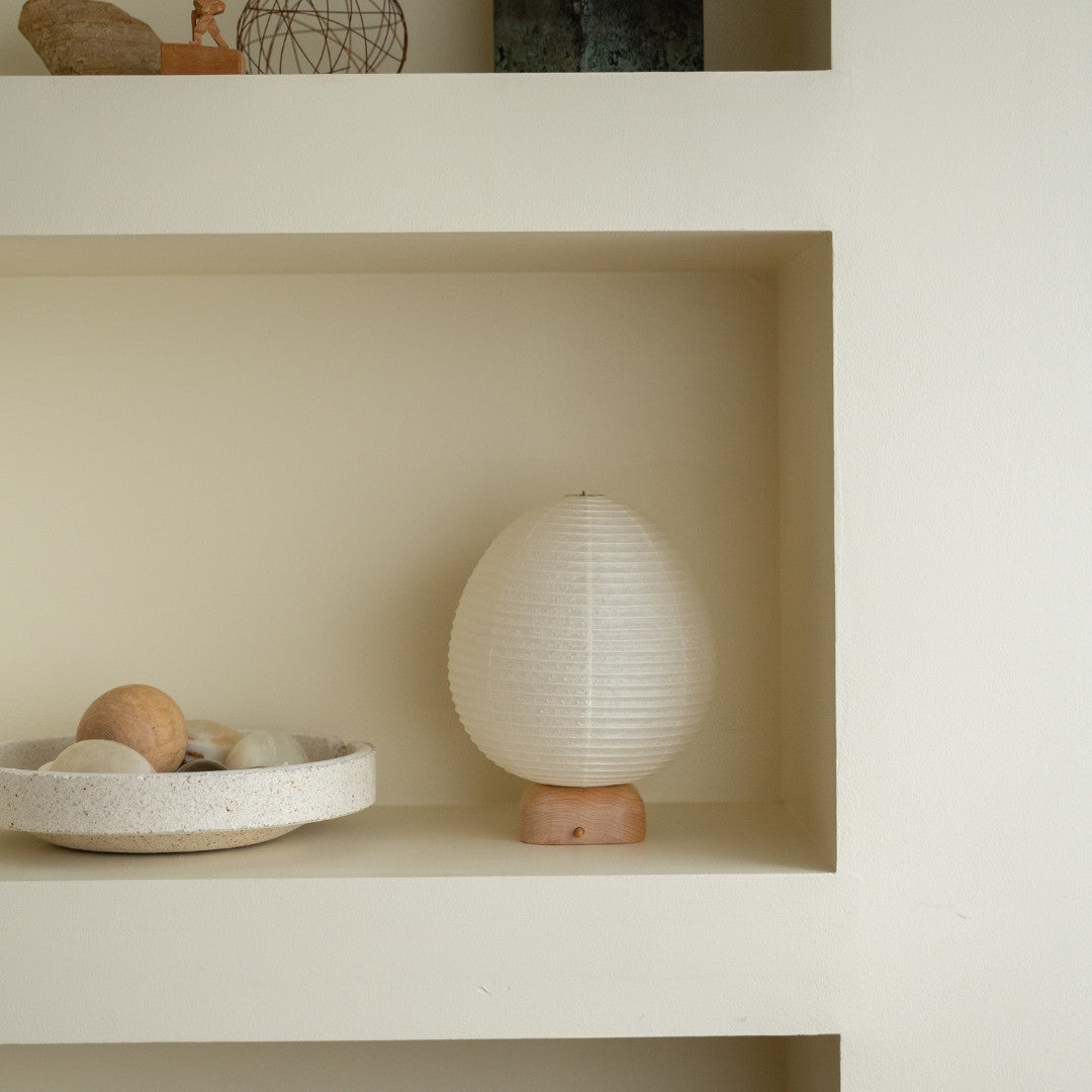 Japanese Paper Table Lamp "Ostrich" on a white shelf in Japandi style room – Wabi-Sabi night lamp for bedside tables