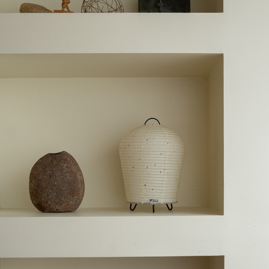 Japanese Paper Table Lamp "PAPERSON 01" on a white shelf in Japandi style room – Unique bedside table lamp for bedroom