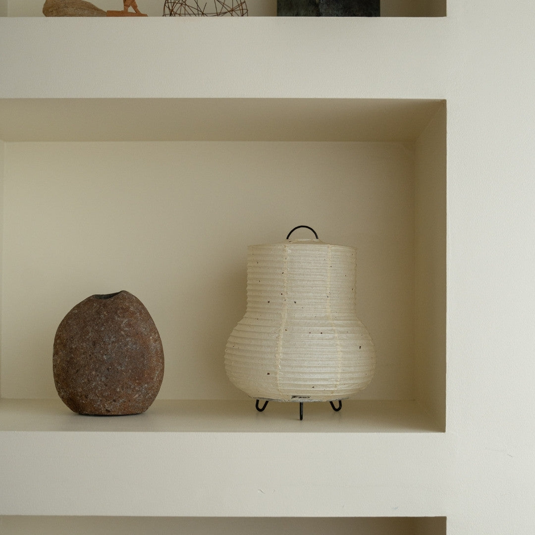 Japanese Paper Table Lamp "PAPERSON 02" on a white shelf in Japandi style room – Wabi-Sabi table lamp for bedside table