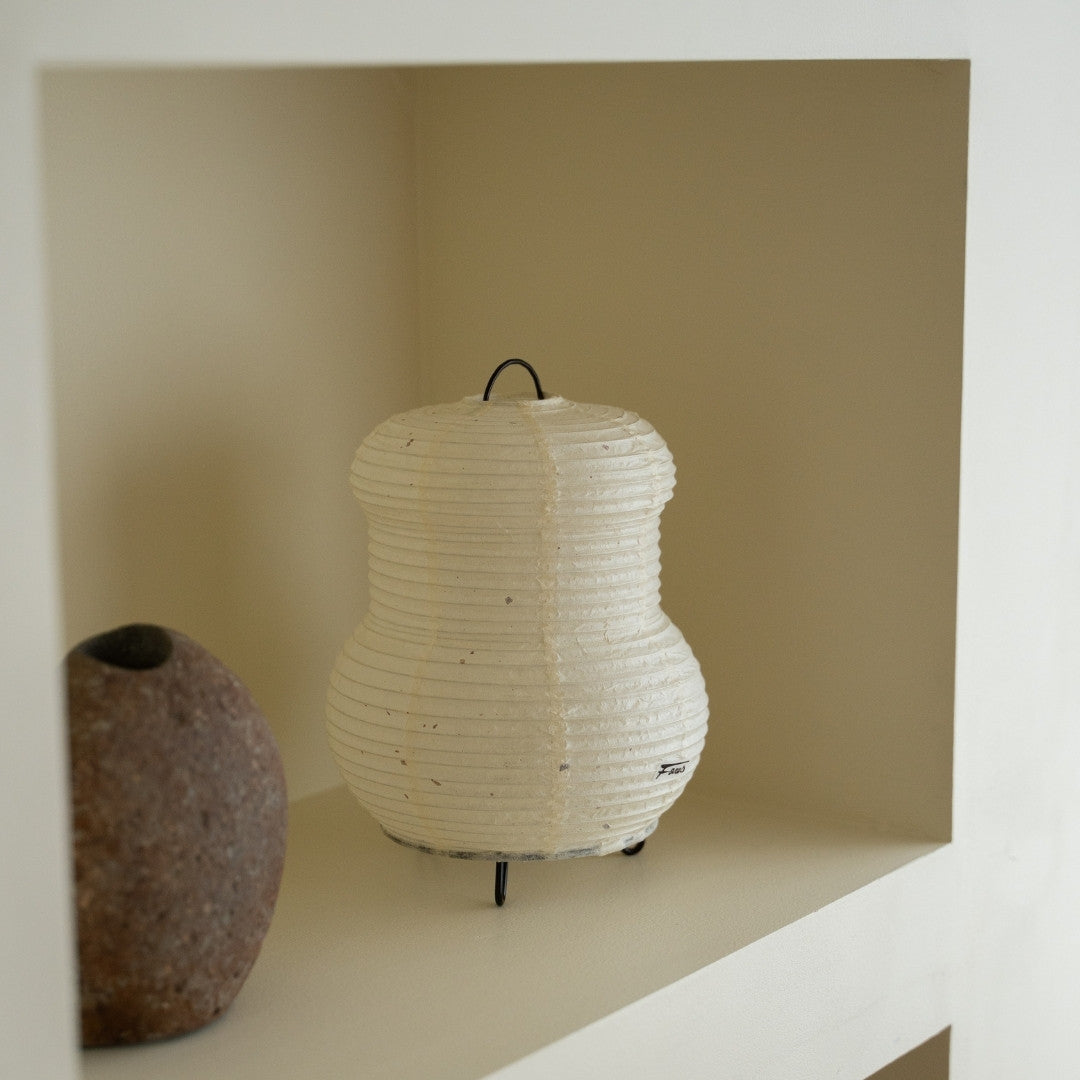 Japanese Paper Table Lamp "PAPERSON 03" on a white shelf in Japandi style room – Wabi-Sabi table lamp for bedside table