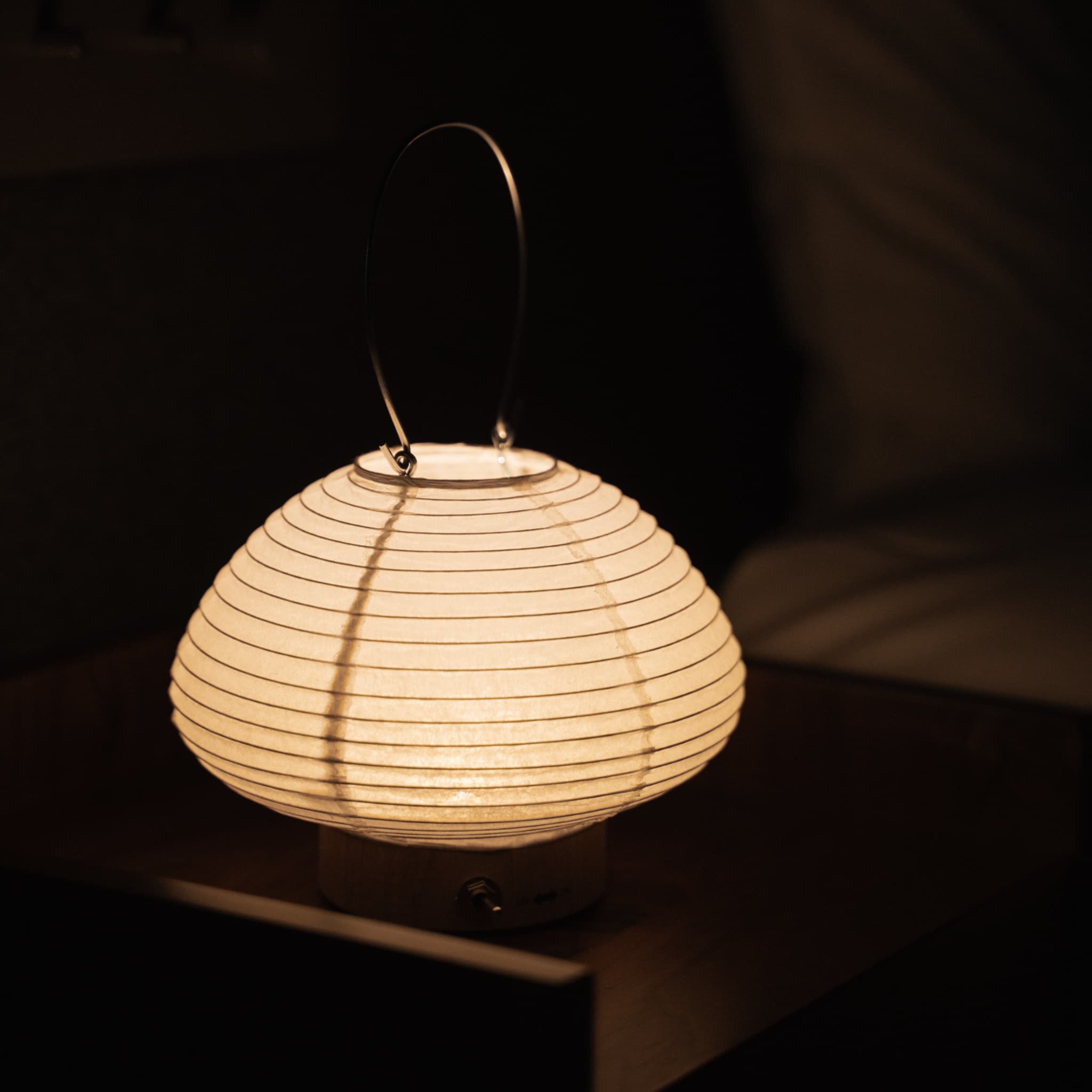 Japanese paper table lamp on a bedside table