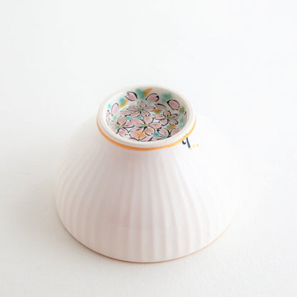 A beautifully detailed Japanese matcha chawan bowl “Waraku” Flower featuring pink cherry blossoms and gold highlights, handcrafted by Buzan Kiln in Gifu, Japan.