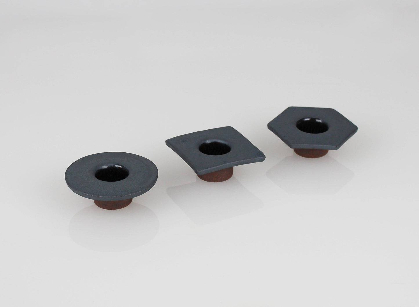 A set of three mini iron-colored vases crafted from Inspired Japanese roof tiles.