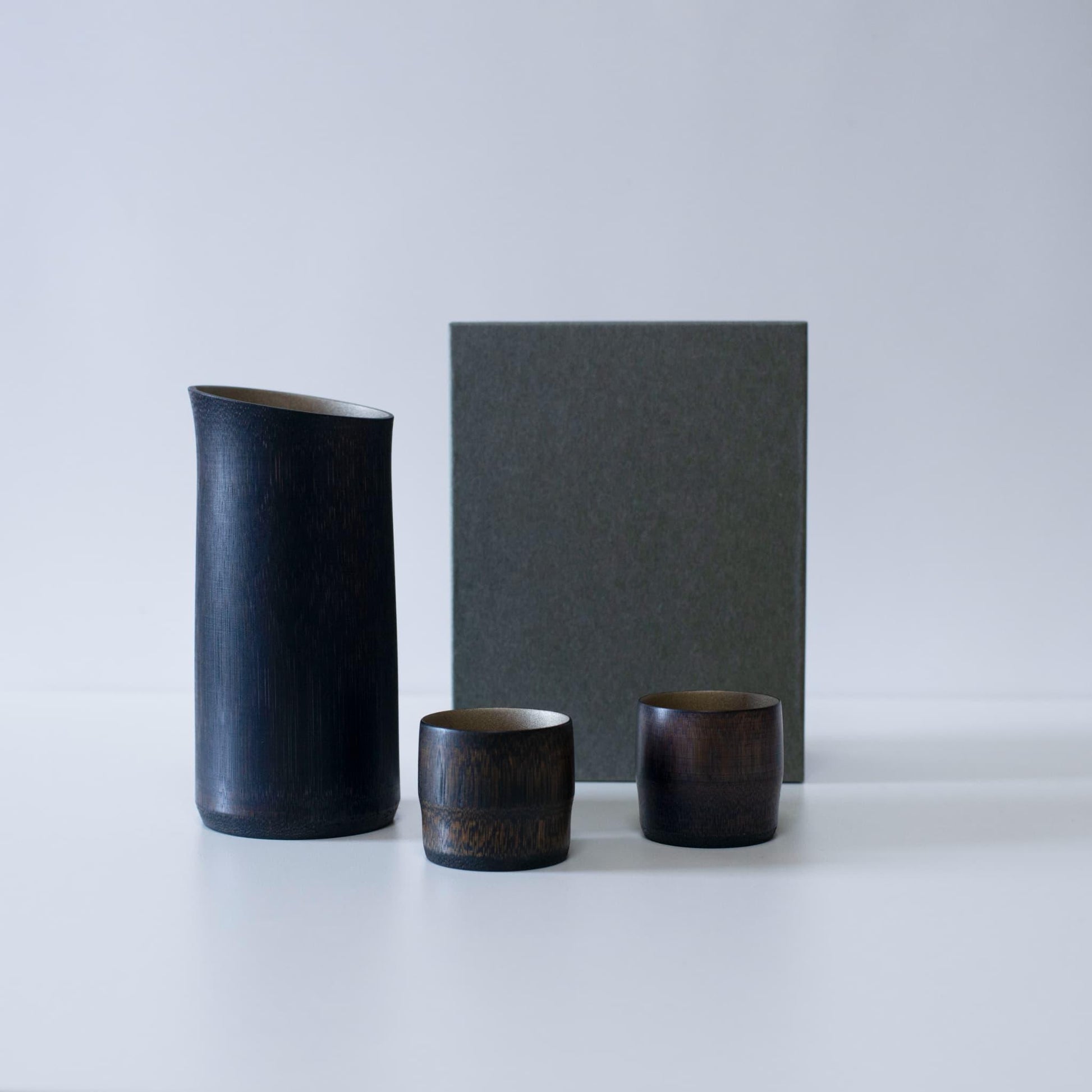 Gift set of black bamboo sake pitcher and cups, crafted with traditional techniques from Kyoto, Japan.