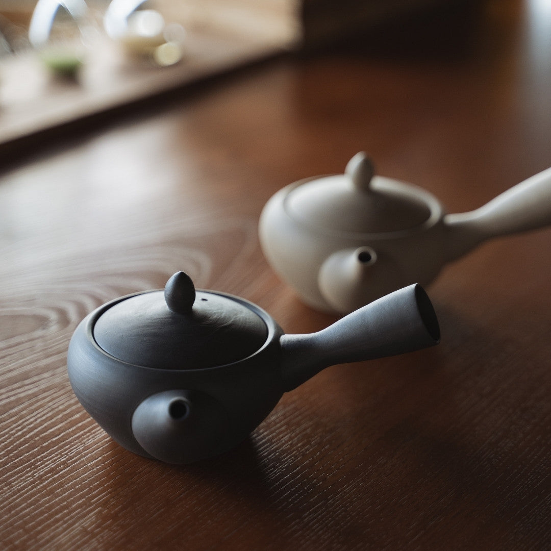 Handcrafted Japanese Teapot Black & White on wooden table in a zen room