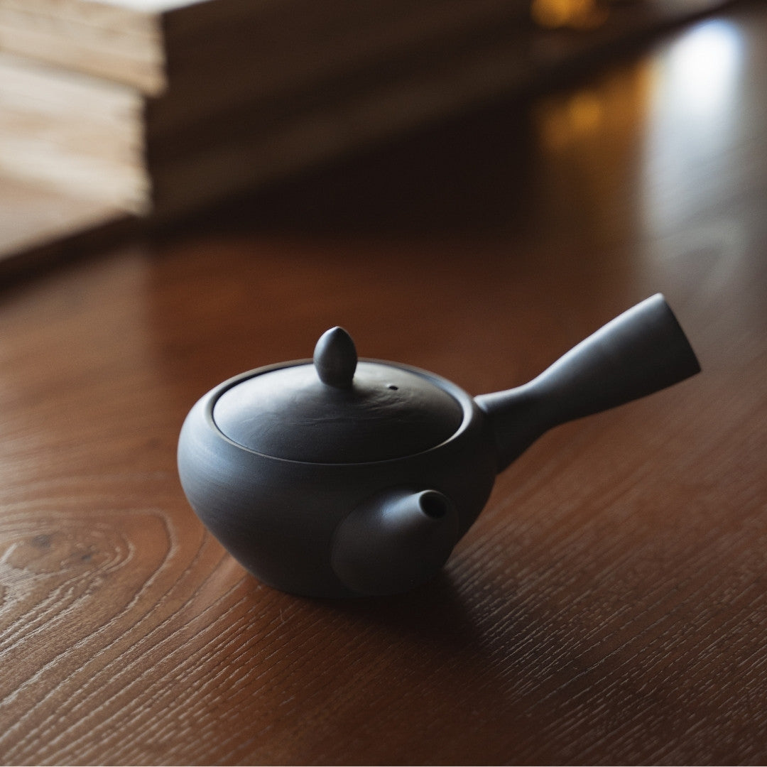 Japanese Teapot (Kyusu) Black on a wooden table in a zen room